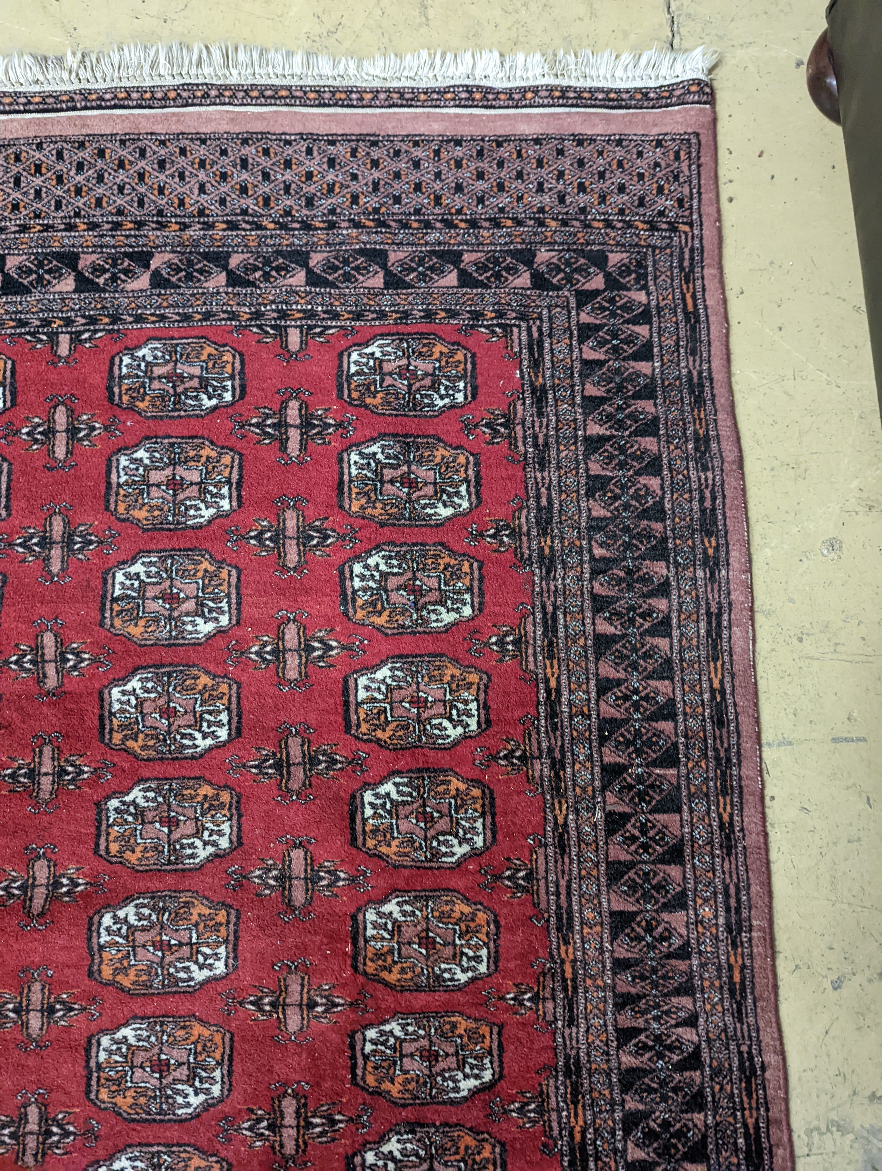 A Bokhara red ground rug, 196 x 126cm